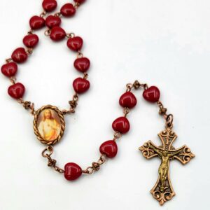 Dark red glass hearts rosary on copper with sacred heart picture center